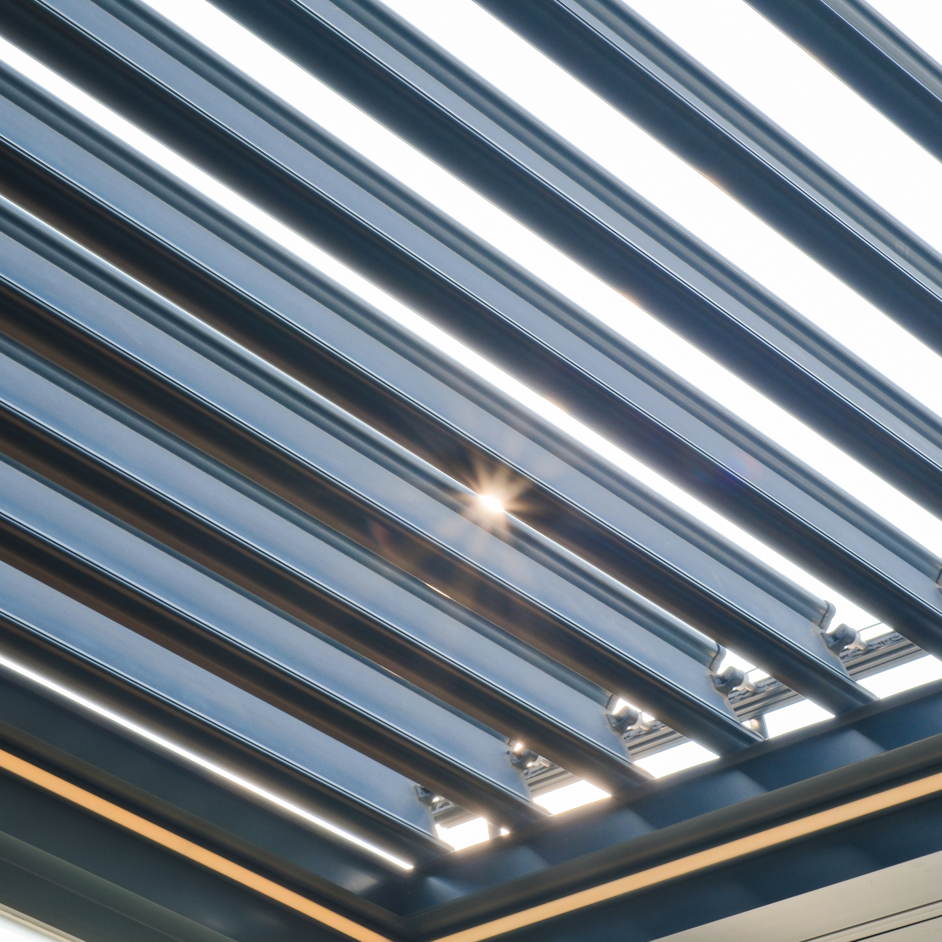 Close-up view of an aluminum louvered pergola roof system by AnkaSpaces, showcasing precision-engineered louvers and modern architectural design.